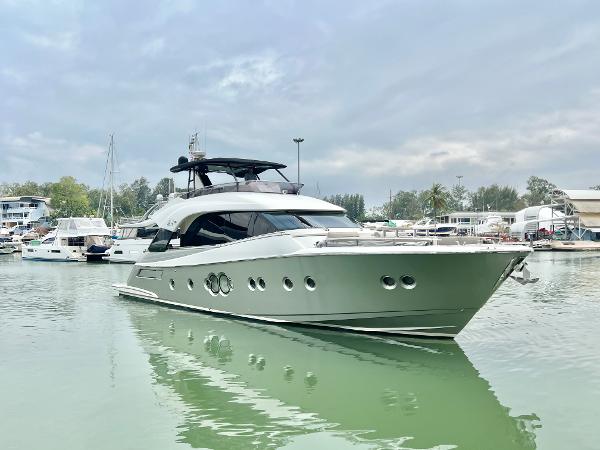 Monte Carlo Yachts MCY 70 2015 Monte Carlo Yachts MCY 70 luxury yacht docked in a serene marina.