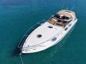 Princess V42 Luxury Princess V42 yacht from 2000 on clear blue water.