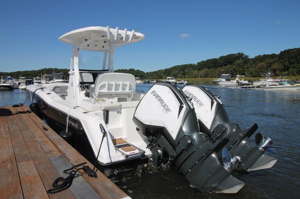 Tidewater 252 LXF 2018 Tidewater 252 LXF boat docked with dual Evinrude engines, sunny day.
