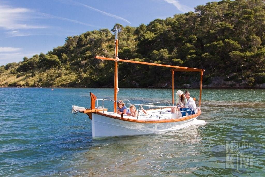 Llaüts Tiburón 30 SOLARIUM ELECTRICO 2023 Llaüts Tiburón 30 Solarium Electrico boat on scenic water with lush green hills.