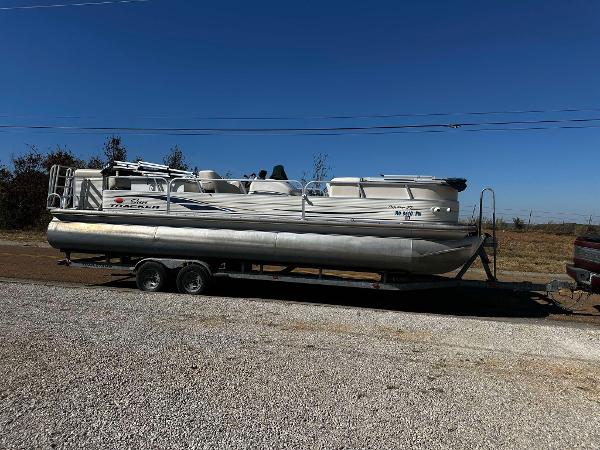 Tracker Sun Tracker Party Barge 27 2007 Tracker Sun Tracker Party Barge 27 on trailer, parked on gravel.