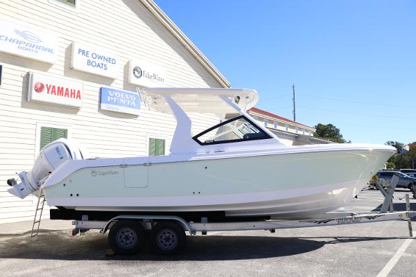 Edgewater 262CX 2024 Edgewater 262CX boat on trailer outside dealership.