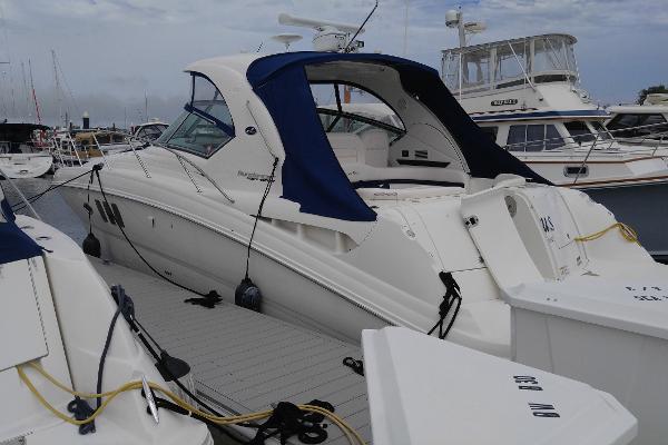 Sea Ray 390 Sundancer 2011 Sea Ray 390 Sundancer yacht docked at marina, featuring sleek design and blue canopy.