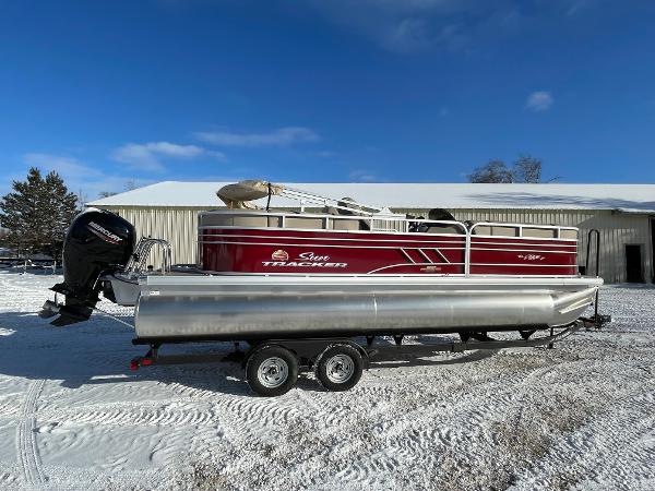 Sun Tracker Party Barge 22 DLX 2023 Sun Tracker Party Barge 22 DLX pontoon boat on snowy ground.