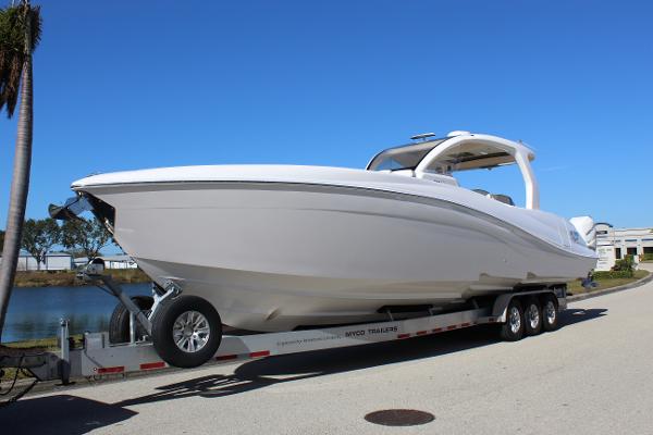 Deep Impact 399 Sport 2019 Deep Impact 399 Sport boat on trailer, parked near water under clear blue sky.