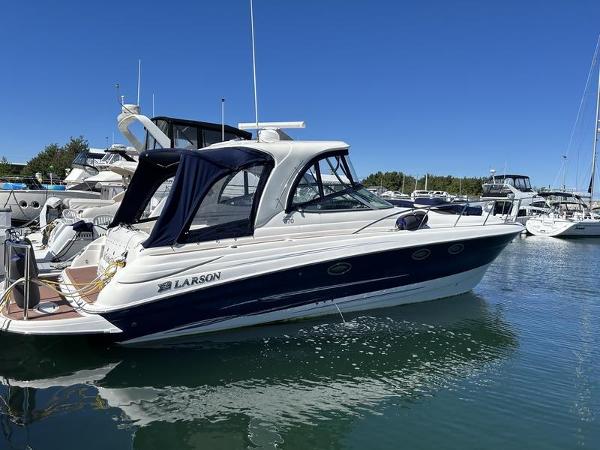 Larson Cabrio 370 2010 Larson Cabrio 370 boat docked in marina under clear blue sky.