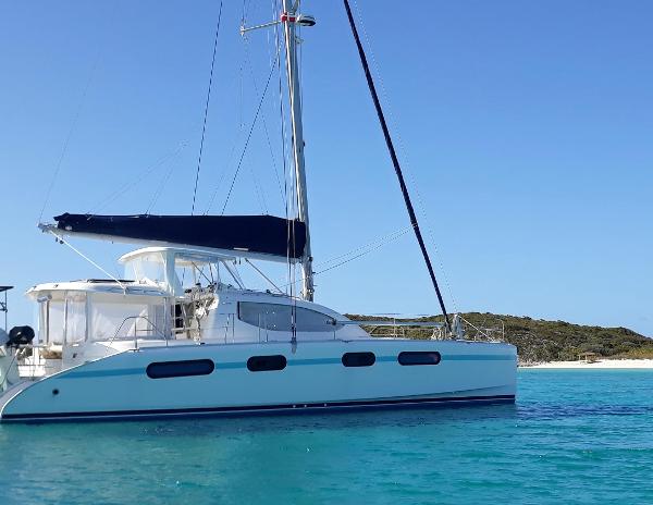 Leopard 46 Sailing catamaran Leopard 46, 2012 model, anchored in clear turquoise waters.
