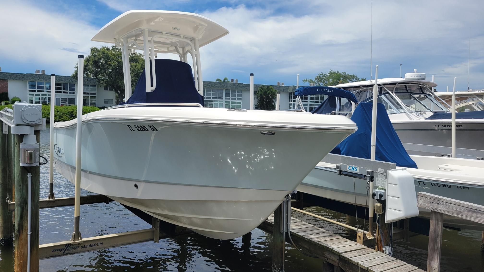 Robalo R230 Center Console 2020 Robalo R230 Center Console boat docked at marina under clear sky.