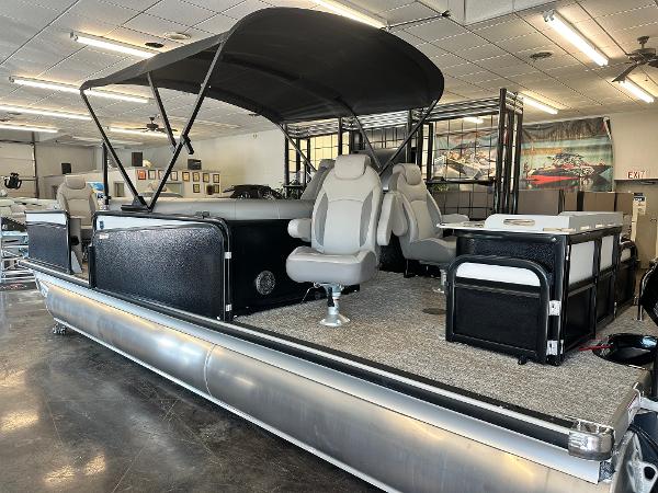 Premier Sunsation 230 Angler 2025 Premier Sunsation 230 Angler pontoon boat with canopy and seating in showroom.