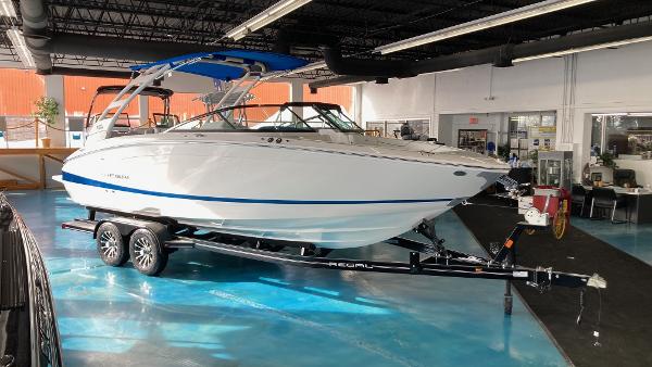 Regal LS6 2024 Regal LS6 boat on a trailer in a showroom.