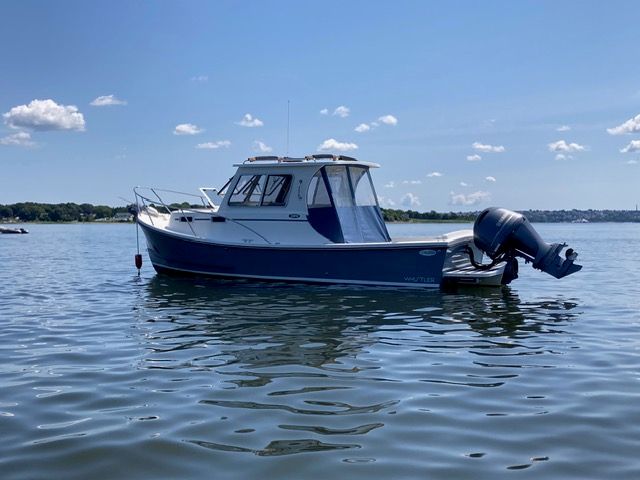 Eastern 248 Islander 2020 Eastern 248 Islander boat on calm water under a clear blue sky.