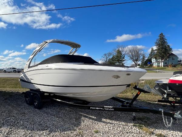 Regal LS4 2025 Regal LS4 boat on trailer under blue sky.