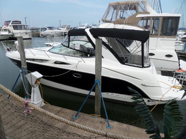 Bayliner 320 Express 2008 Bayliner 320 Express docked at marina, featuring sleek black and white design.