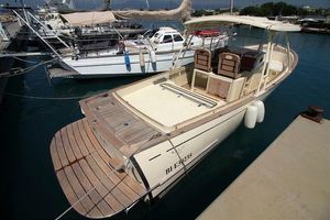 Rhea 35 Open 2010 Rhea 35 Open boat docked at marina, featuring spacious deck and seating.