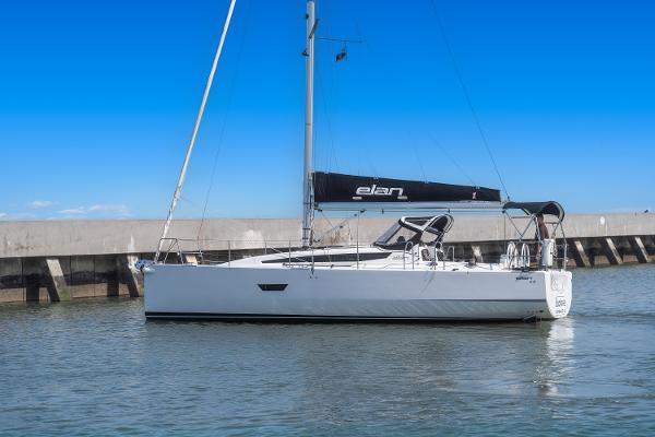 Elan E4 2017 Elan E4 sailboat docked in calm waters under a clear blue sky.