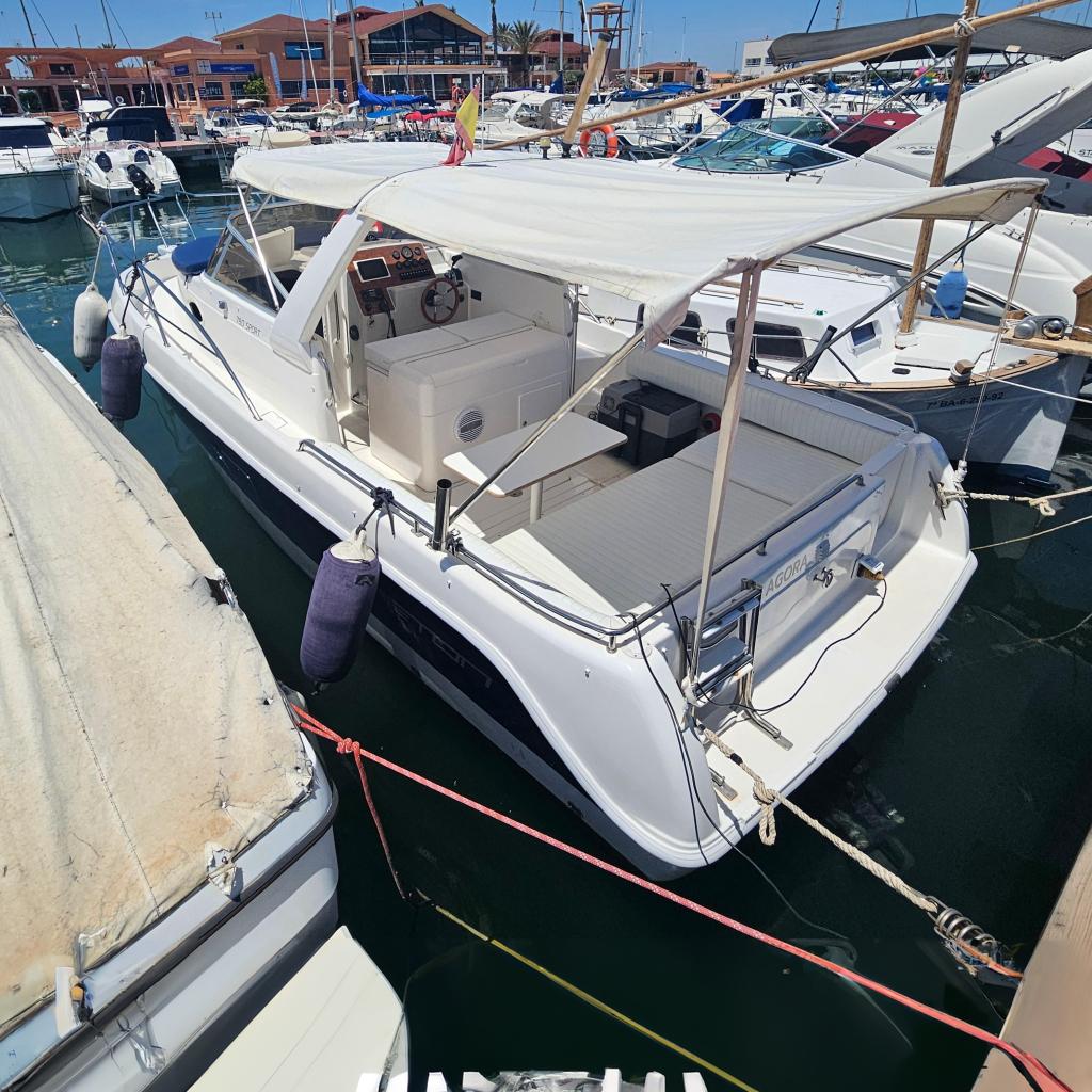 Faeton 780 Faeton 780 boat from 2000 docked at a marina under clear blue skies.