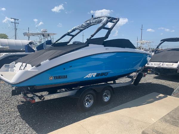 Yamaha Boats AR250 2023 Yamaha Boats AR250, blue and white, on a trailer in a marina.