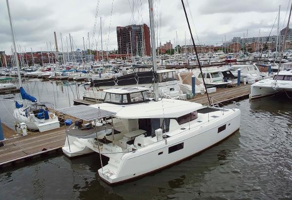 Lagoon 42 2019 Lagoon 42 catamaran docked in a busy marina with other boats.
