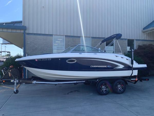 Chaparral 224 Sunesta 2012 Chaparral 224 Sunesta boat on a trailer outside a building.