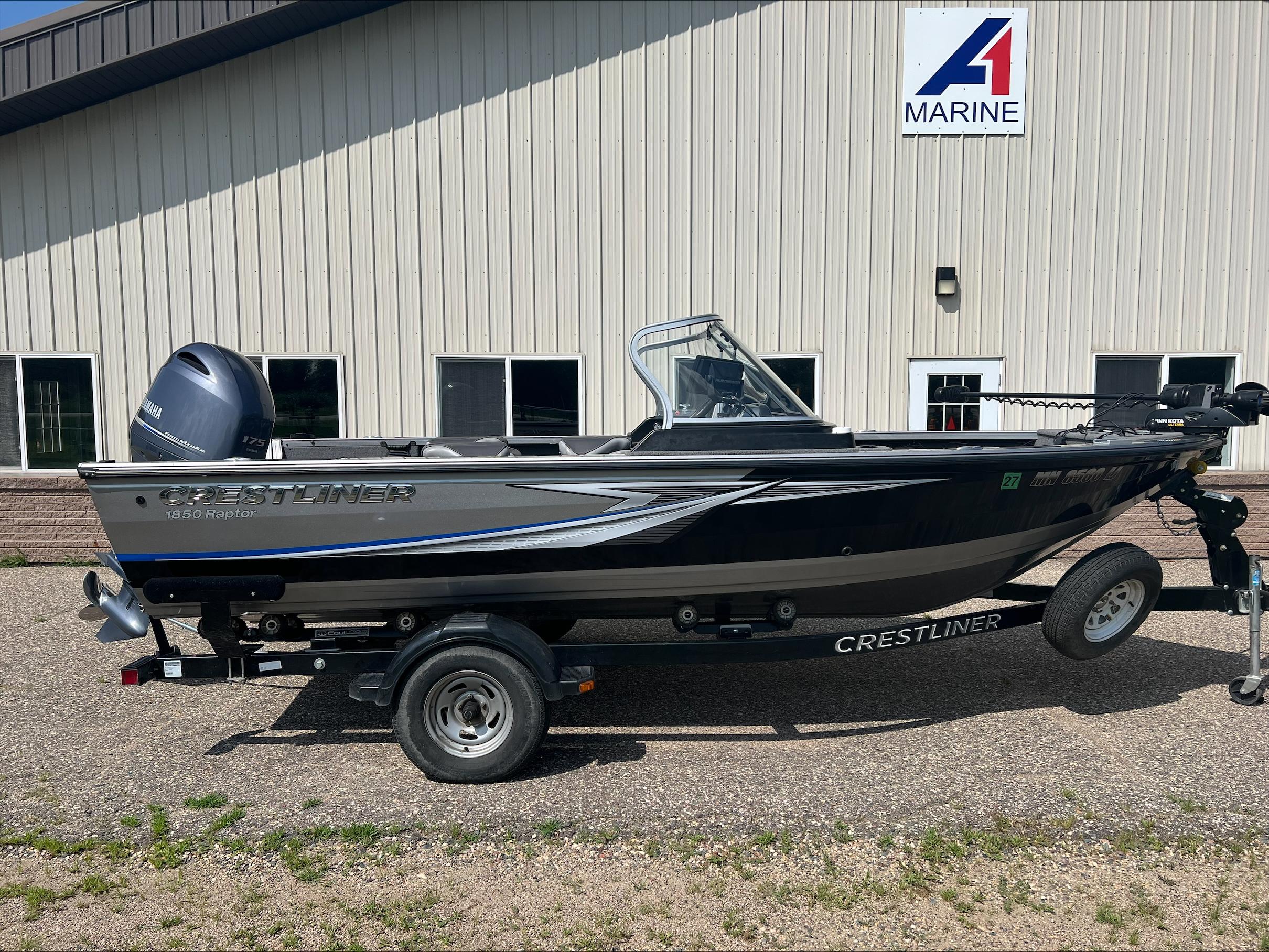 Crestliner Raptor 1850 2016 Crestliner Raptor 1850 boat on trailer, parked outside a marine dealership.