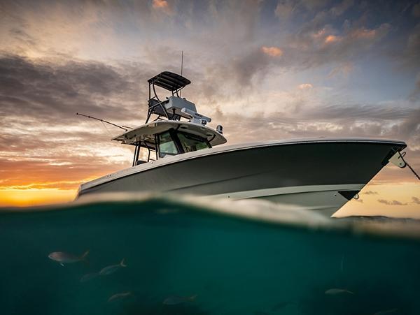 Boston Whaler 360 Outrage 2024 Boston Whaler 360 Outrage at sunset, partially submerged in water.