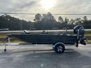Xpress H18 Bass 2025 Xpress H18 Bass boat on trailer, parked outdoors under cloudy sky.