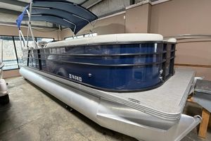 Crest Classic Platinum 240 SLC 2021 Crest Classic Platinum 240 SLC pontoon boat with blue exterior in indoor storage.