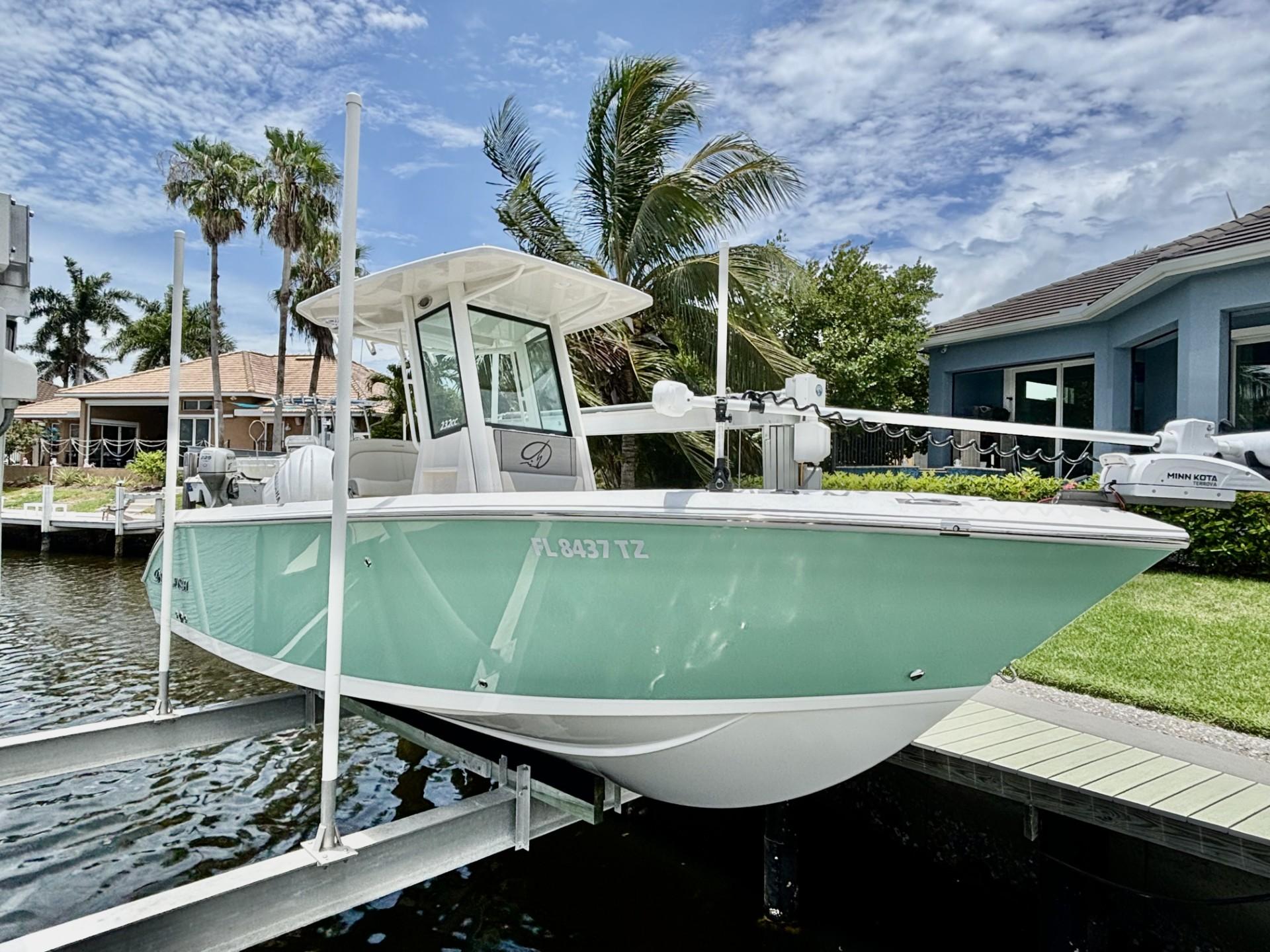 Sailfish 232 CC 2025 Sailfish 232 CC boat docked, featuring a sleek design and mint green hull.