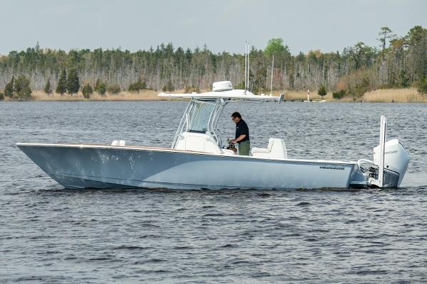 Valhalla Boatworks V-29 Hybrid 2026 Valhalla Boatworks V-29 Hybrid on a serene lake with forested background.