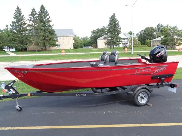 Lund 1650 Angler 2024 Lund 1650 Angler boat in vibrant red on a trailer, parked outdoors.