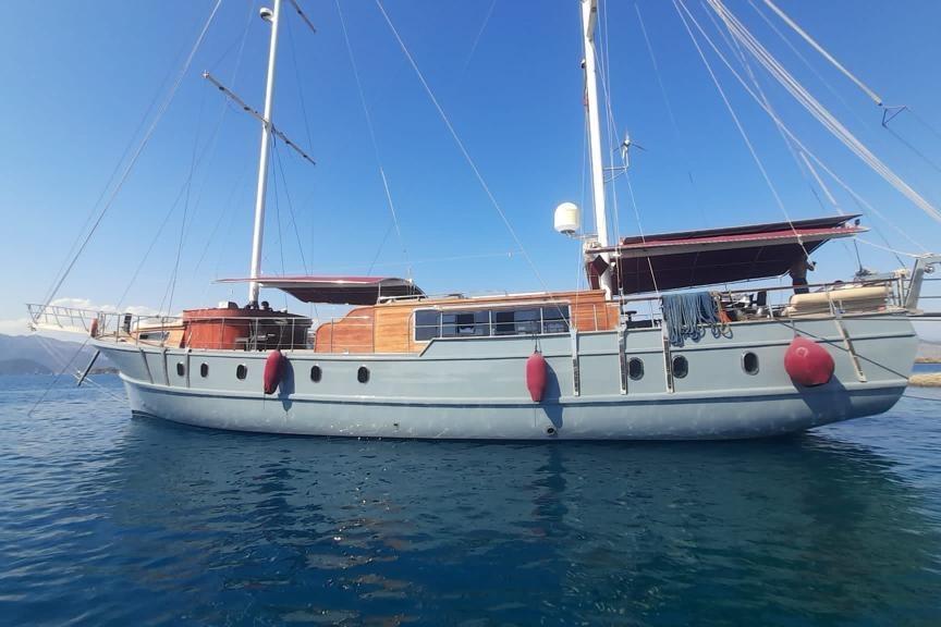Custom Gulet Motorsailer Custom 2003 Gulet Motorsailer on calm blue waters, featuring wooden accents and red fenders.