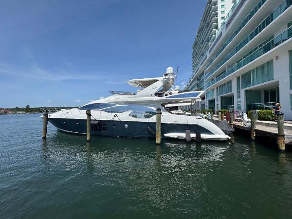 Azimut Flybridge 2014 Azimut Flybridge yacht docked beside modern waterfront building.