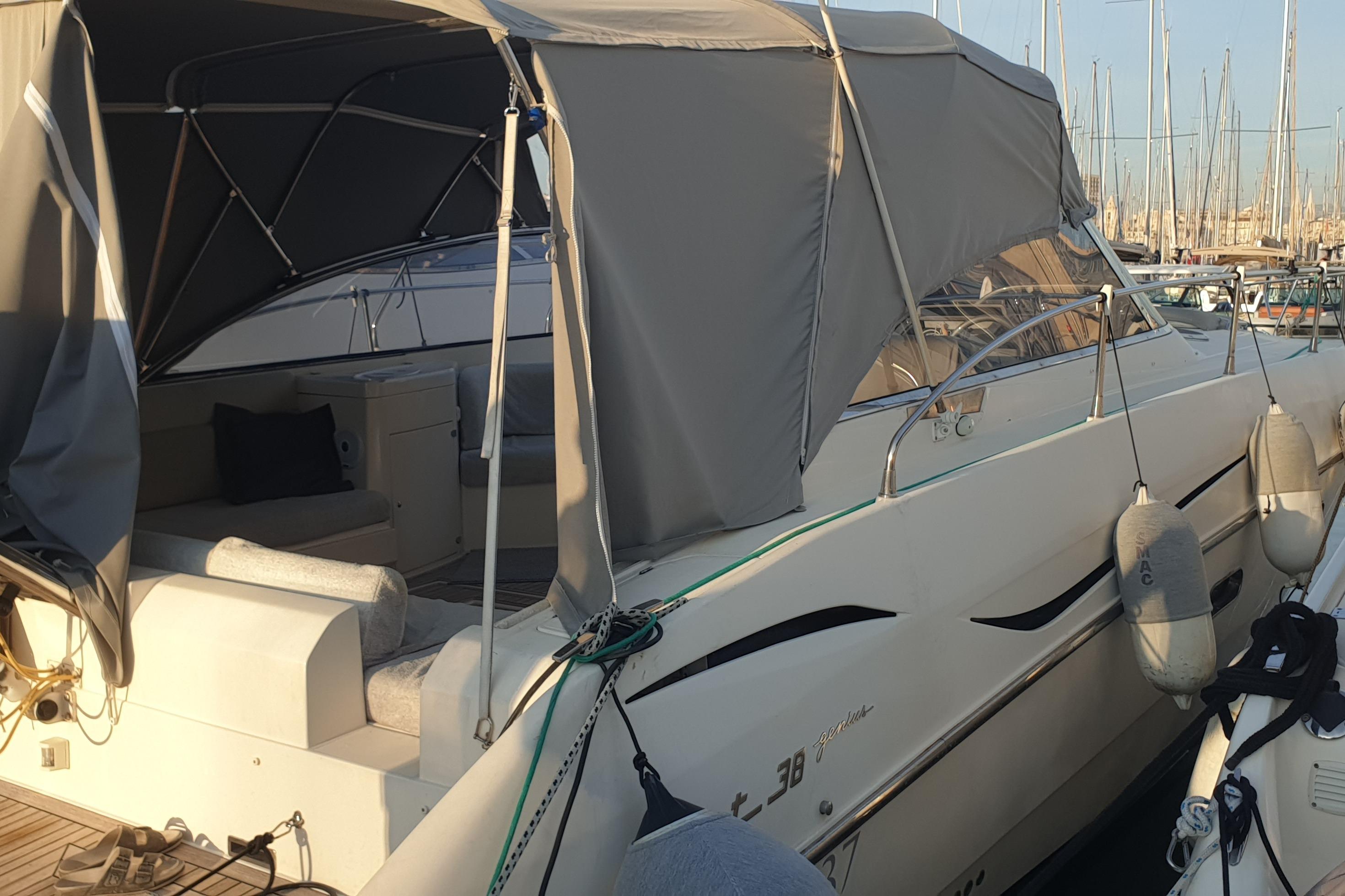 Fiart 38 2006 Fiart 38 yacht with canopy, docked in marina, side view.