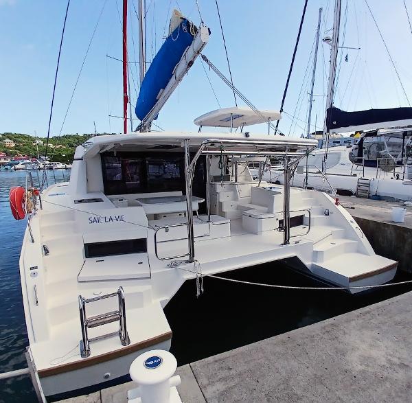 Leopard 45 2019 Leopard 45 catamaran docked at marina, featuring spacious deck and modern design.