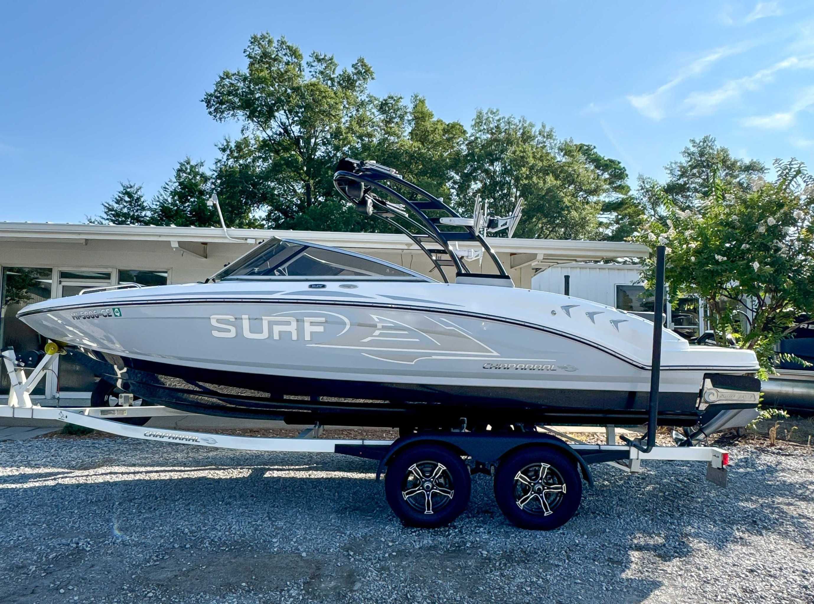 Chaparral 23 Surf 2021 Chaparral 23 Surf boat on trailer, parked outdoors.