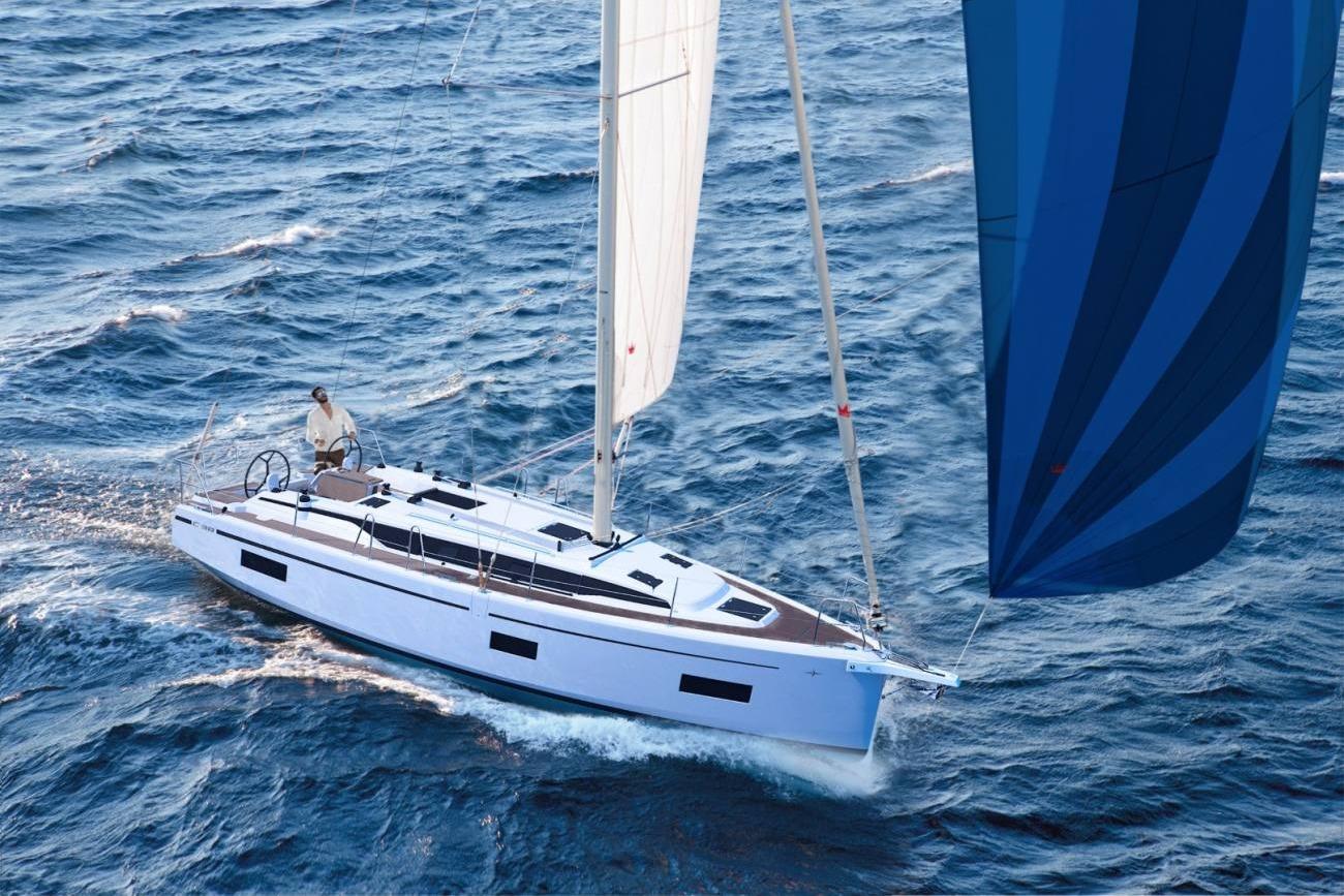 Bavaria C38 2025 Bavaria C38 yacht sailing on open sea with blue and white sails.