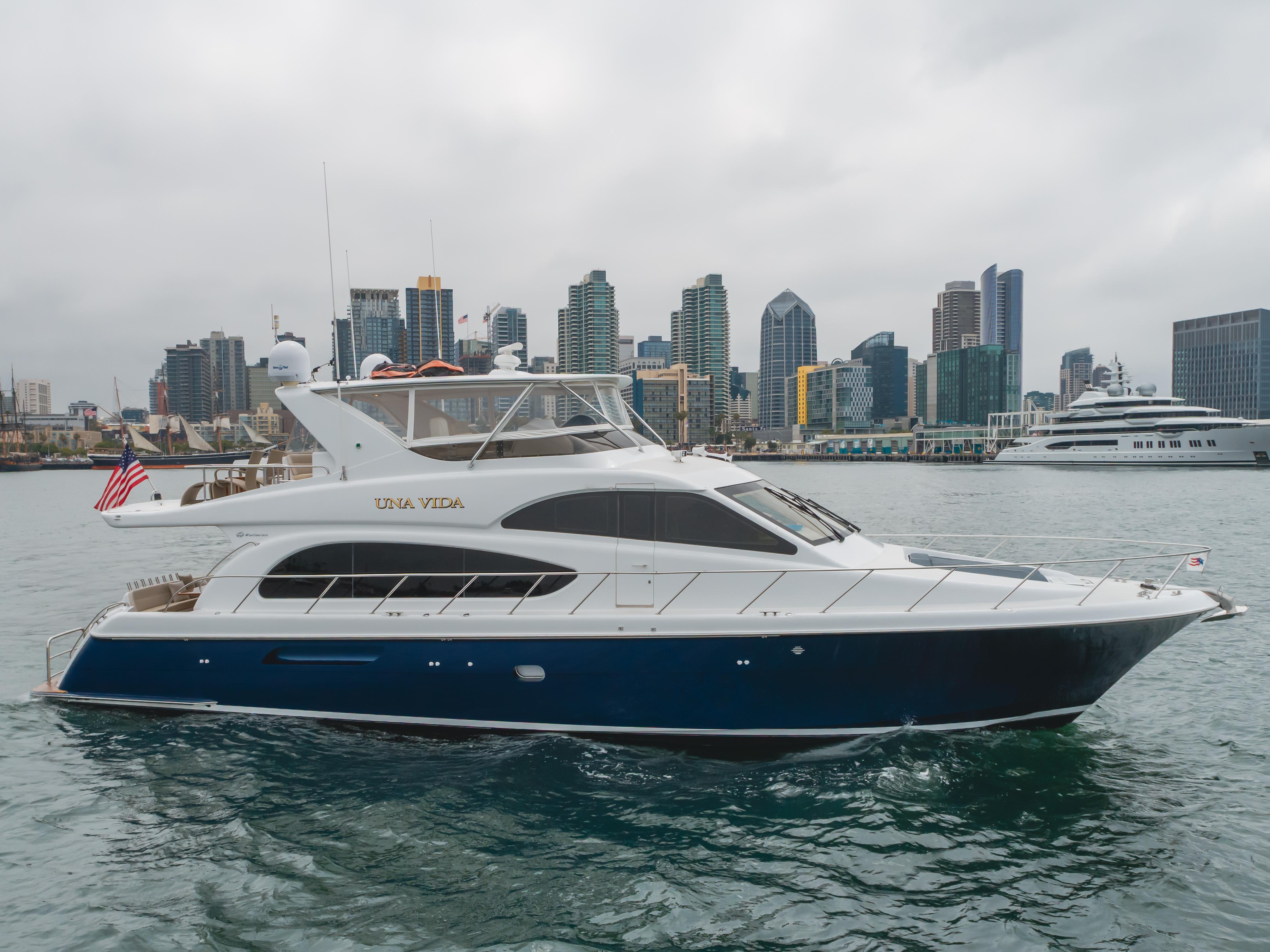 Hatteras 64 Motor Yacht 2007 Hatteras 64 Motor Yacht cruising near city skyline, featuring sleek design and luxury amenities.