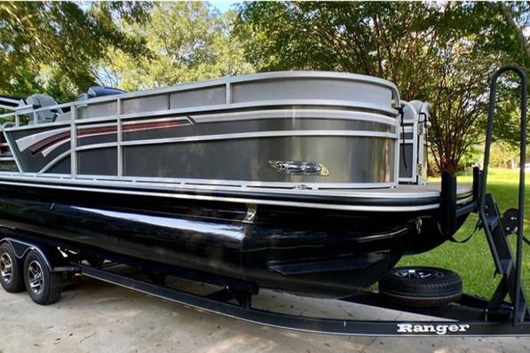 Ranger Reata 220C 2023 Ranger Reata 220C pontoon boat on trailer, parked outdoors.