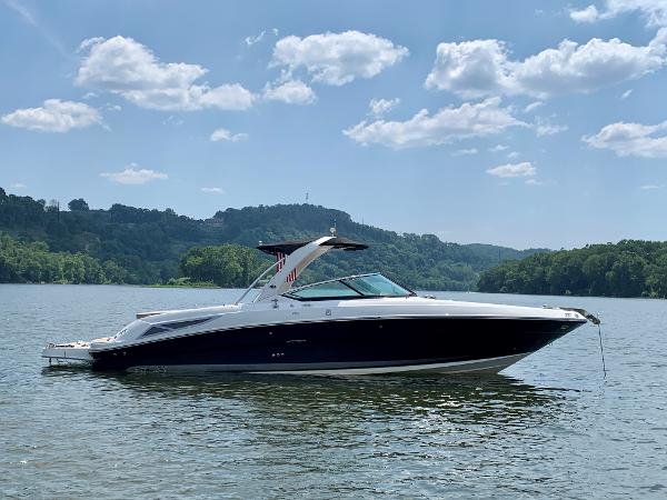 Sea Ray 300 SLX 2011 Sea Ray 300 SLX boat on a scenic lake with hills and clouds.