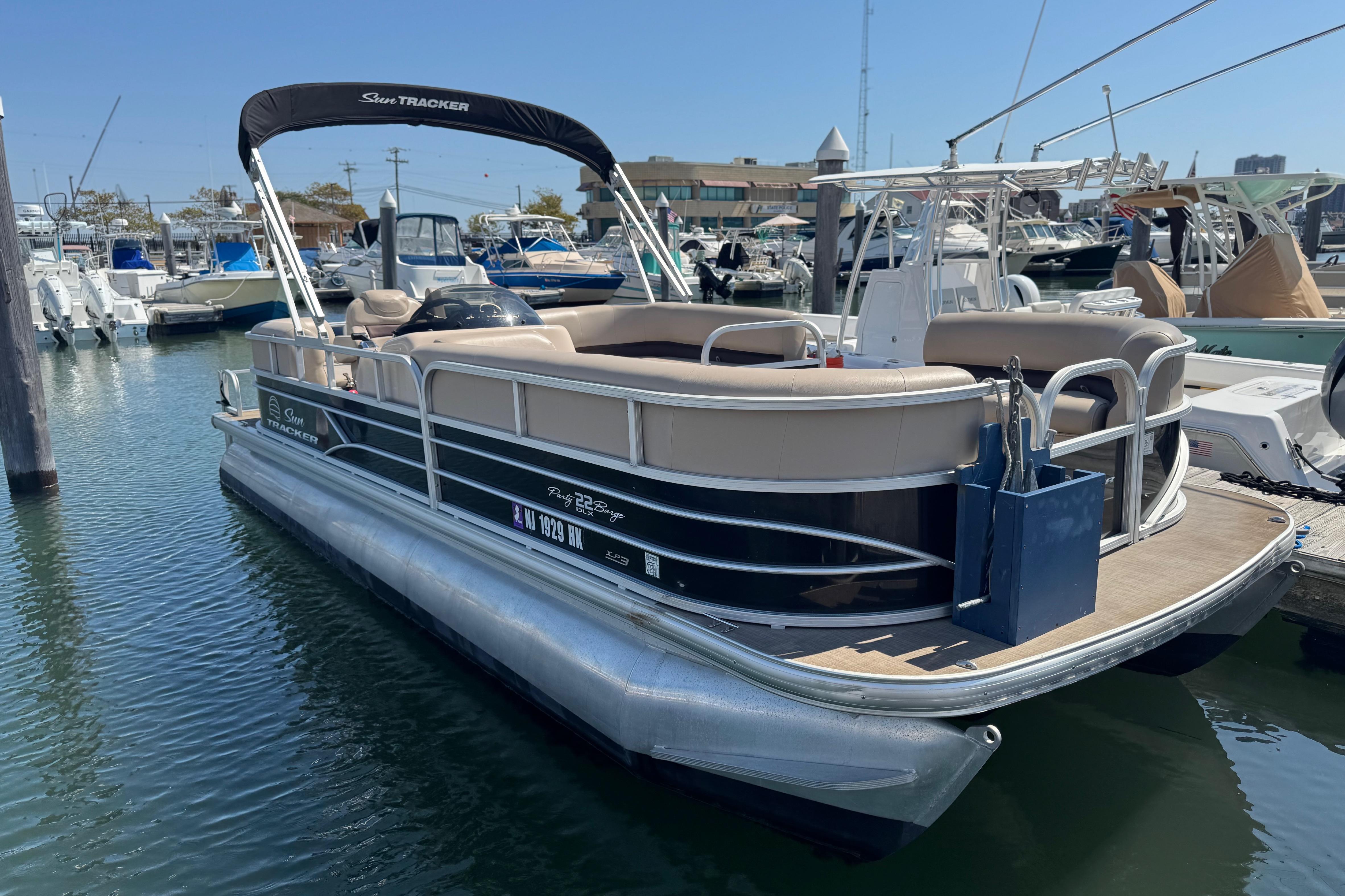 Sun Tracker Party Barge 22 DLX 2017 Sun Tracker Party Barge 22 DLX pontoon boat docked at marina.