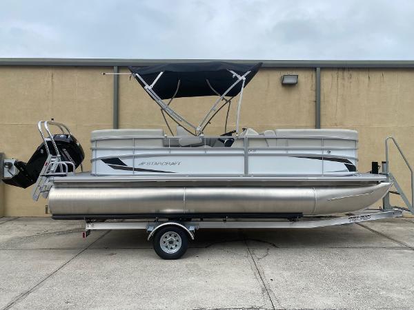 Starcraft LX 20 R 2024 Starcraft LX 20 R pontoon boat on trailer, featuring a sleek design and canopy.