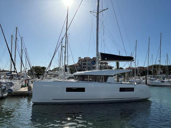 Lagoon 40 2024 Lagoon 40 catamaran docked in a marina under clear blue skies.