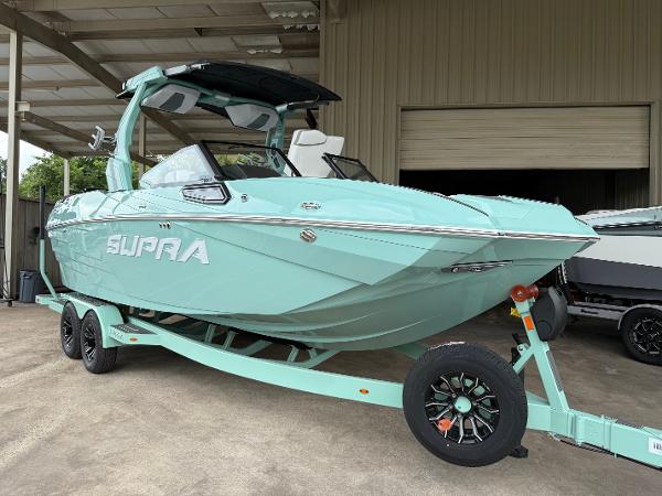 Supra SE 550 2025 Supra SE 550 boat in mint green on trailer, parked in a garage.