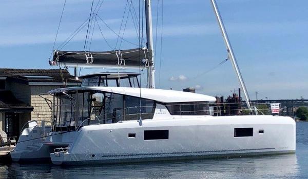 Lagoon 42 2024 Lagoon 42 catamaran docked at a marina.