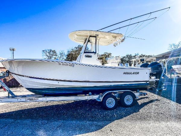 Regulator 23 2023 Regulator 23 boat on trailer, side view, outdoors, sunny day.