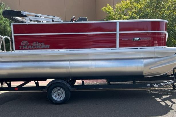 Sun Tracker Party Barge 16 DLX 2026 Sun Tracker Party Barge 16 DLX pontoon boat on trailer, red and silver design.