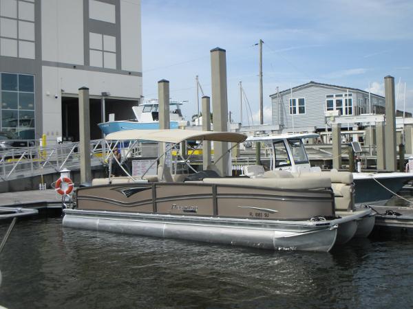 Premier 270 Intrigue RF 2018 Premier 270 Intrigue RF pontoon boat docked at a marina.