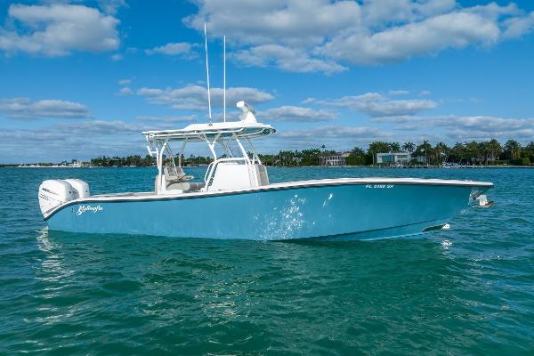Yellowfin 32 2025 Yellowfin 32 boat on clear blue water under a partly cloudy sky.