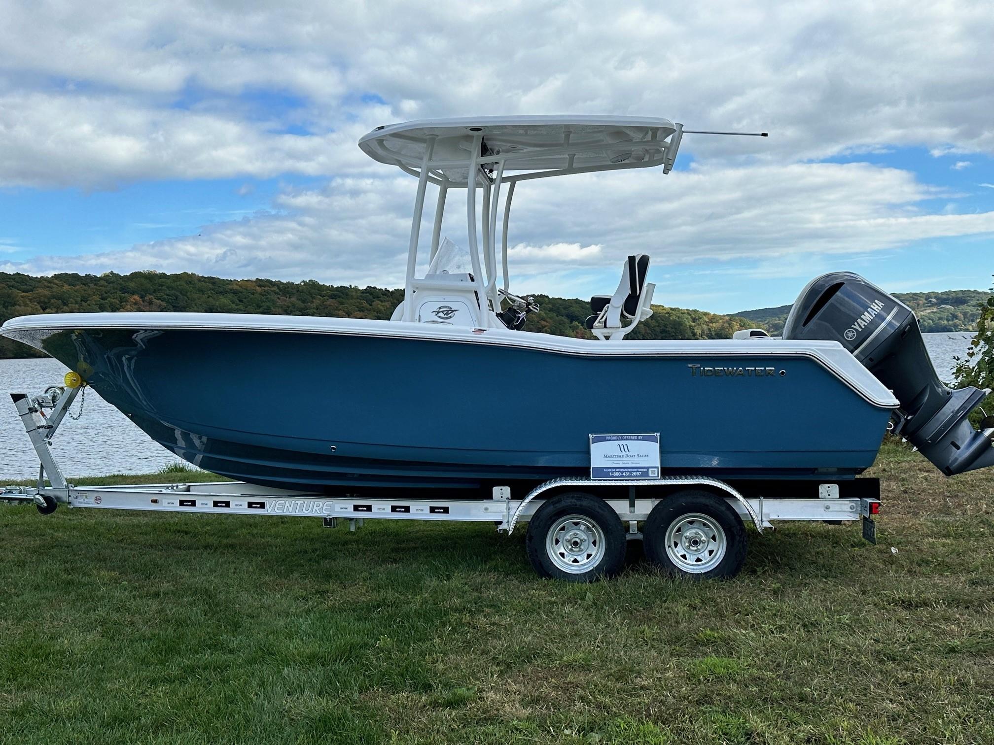 Tidewater 220 Center Console 2025 Tidewater 220 Center Console boat on trailer by a lake.