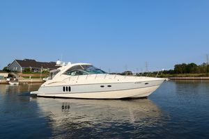 Cruisers Yachts 520 Express 2005 Cruisers Yachts 520 Express on calm water near shoreline homes.